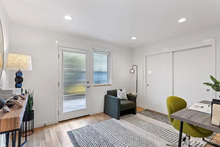 The second first level bedroom has wide plank oak flooring and it’s own separate entry from the private parking spot with E/V outlet for charging.