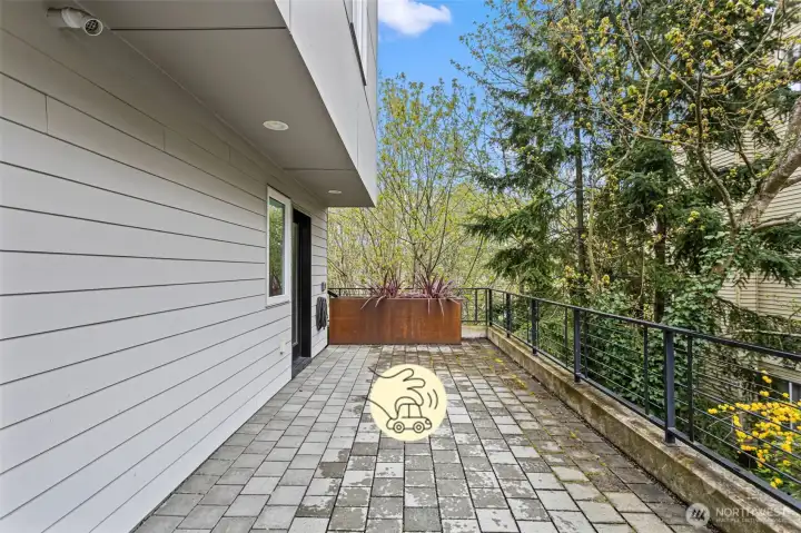 Just outside of the first level bedroom is a private parking spot which features an E/V outlet.  There is also a steel planter which is a rain gutter outlet.