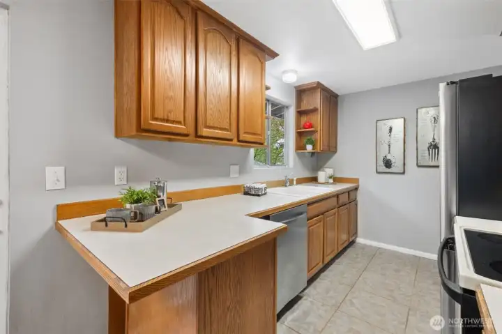 Functional kitchen with ample counter space and warm wood cabinetry.