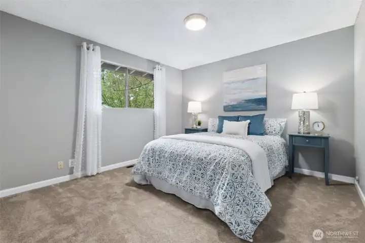 Comfortable bedroom with soft natural light and cozy ambiance.