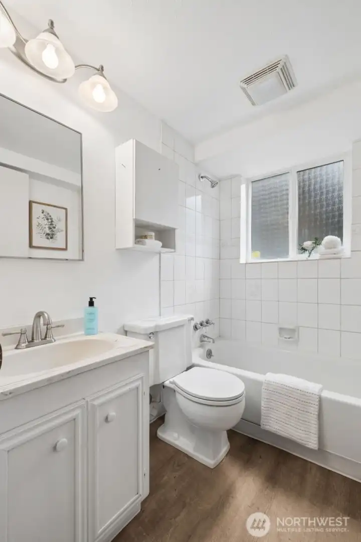 Full bathroom with functional design and plenty of storage.