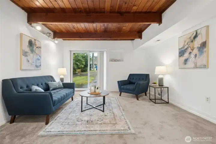 Warm and inviting living area with beautiful wood ceiling detail.