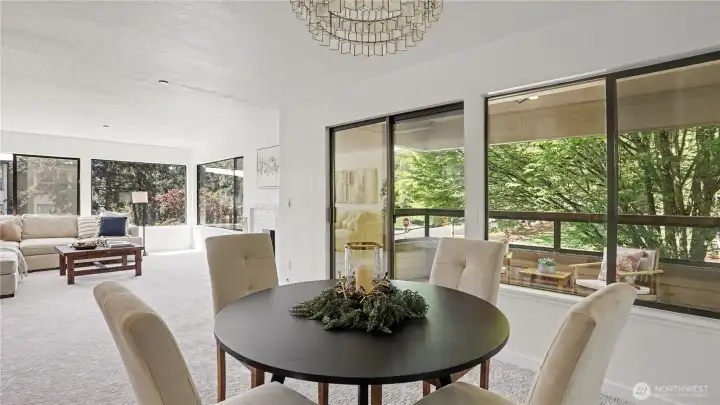 Dining area is subtly separated from the kitchen, with sliding glass doors that open up to a private balcony, offering serene park views.