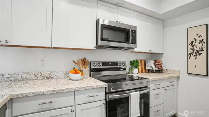 The kitchen is equipped with stainless steel appliances, combining style and functionality for all your culinary adventures.