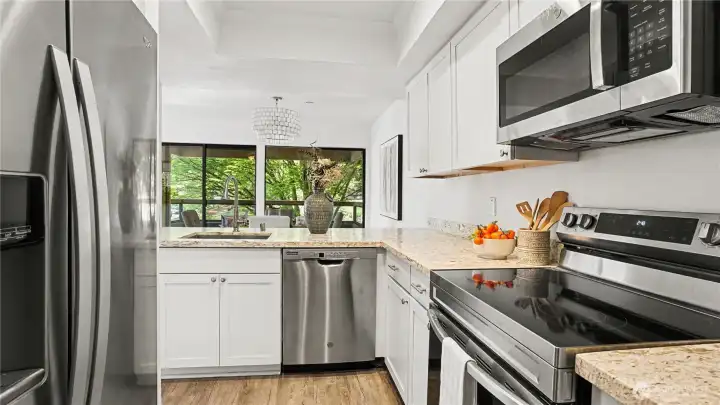 A bright and functional kitchen designed for both style and convenience, featuring a pass through to the dining and living room.