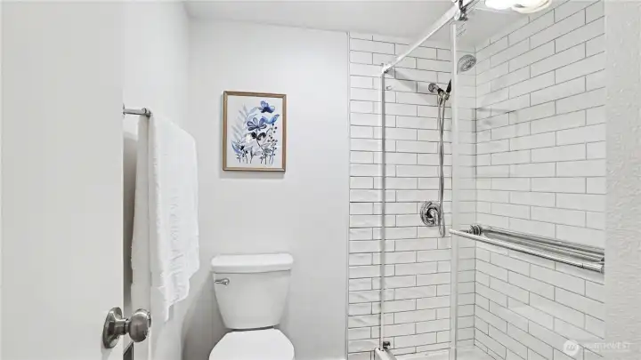 Primary en-suite with toilet and shower conveniently tucked away.