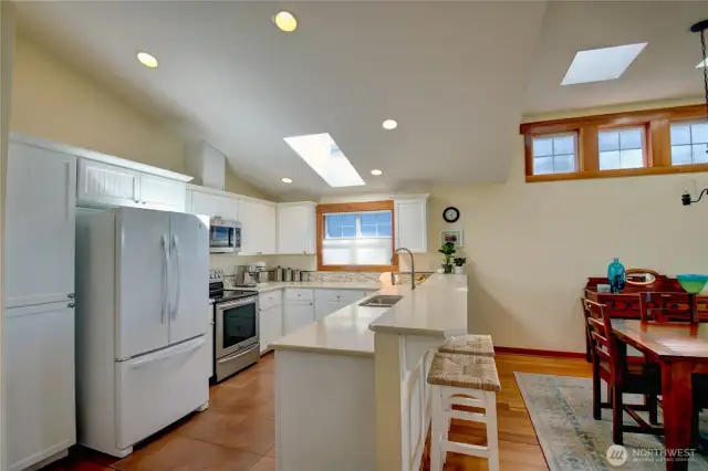 Kitchen with tile floor, plenty of counter space, cupboards and storage space.