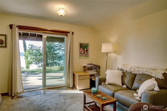 Lower Level: Flex space with sliding glass door to patio and beach path.