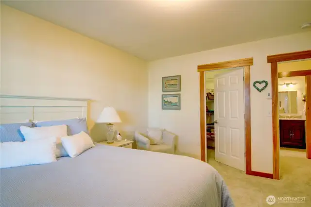 Primary bedroom door on left to walk-in closet, door on right opens to 3/4 bath