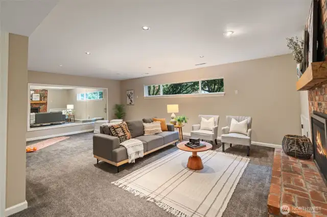 Lower-level recreation room with a cozy gas fireplace.