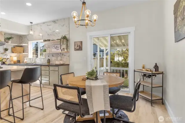 Enter off your kitchen/dining room to a covered patio and fully fenced back yard!