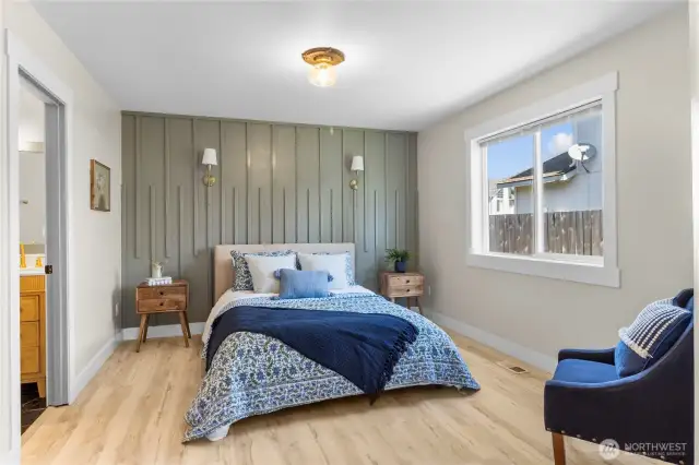 Large Primary Suite! Offers custom designer flair with this gorgeous accent wall and updated lighting!