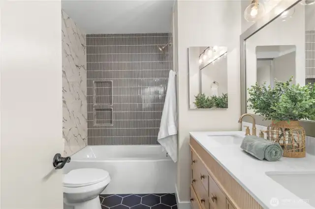 Fully updated tile in the primary bath, new vanity and light fixtures!