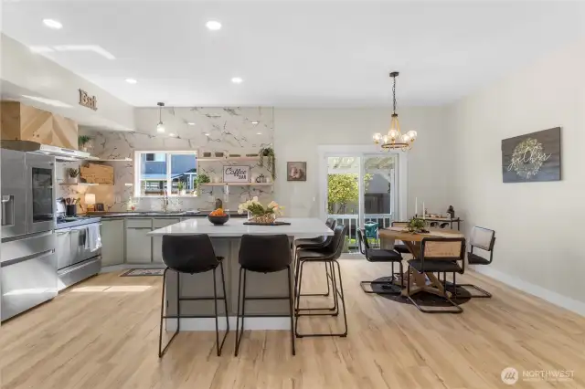 Tastefully updated kitchen with modern tile backsplash reaches from the counter to ceiling! With lots of cabinetry for storage!