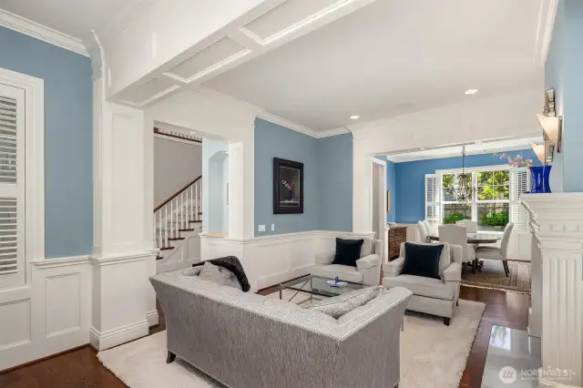 Formal living room shares southern view through dining room to gardens