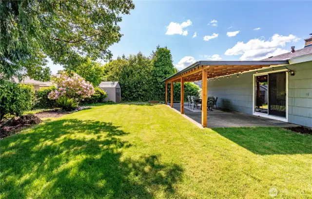 Your very own private oasis filled with lush landscape and covered area.