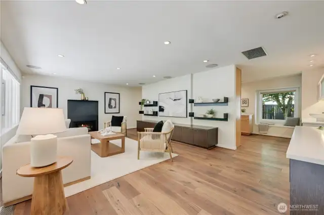 Gracious open living spaces with gas fireplace, gorgeous, engineered wood floors and lovely custom built-in's.