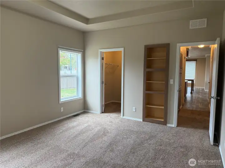 Primary Bedroom with walk in closet & built in bookshelf
