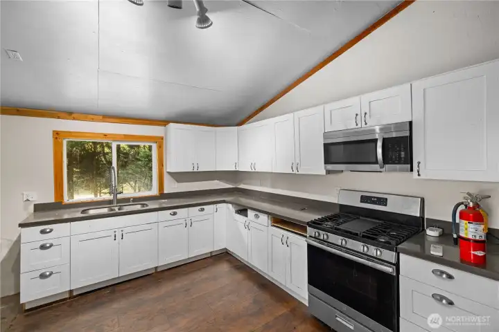 Kitchenette including range and refrigerator.