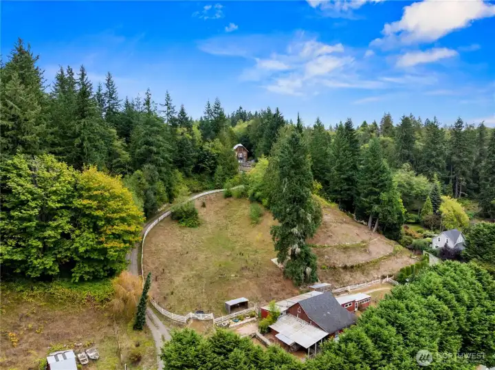An aerial photo shows the home and expansive pastoral beauty of this property. The barn and multiple out-buildings round out this amazing offering.