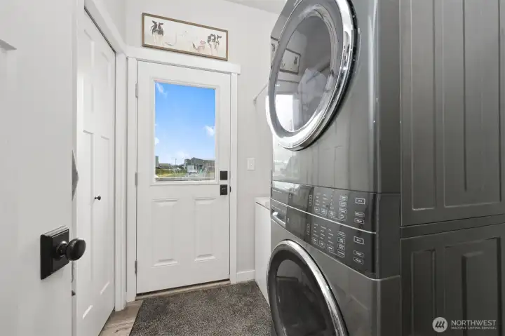 Laundry room with room for freezer, coat closet and exterior door to fenced yard.
