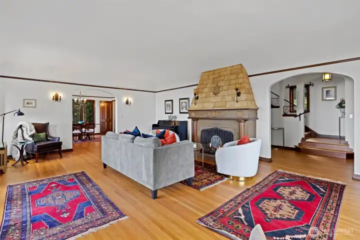 Living room fireplace accented by original wall sconces, creating a warm and inviting focal point.