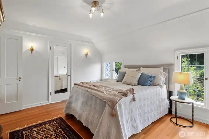 The windowed door houses the en suite bathroom.