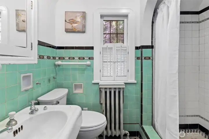 This bedroom features a spacious play area, a cutout with French doors leading to a sleeping nook, and an en suite bathroom for convenience and privacy.