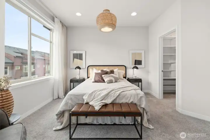 Primary suite with full bathroom and walk in closet.