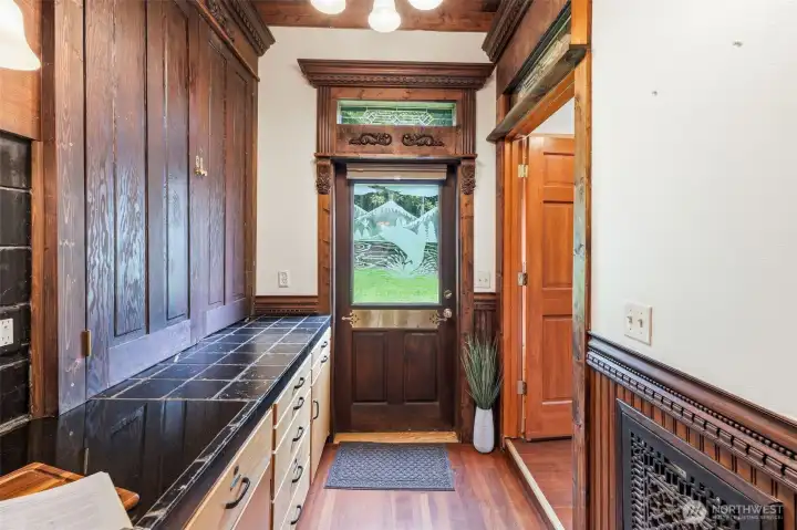 Stairs to the right of kitchen