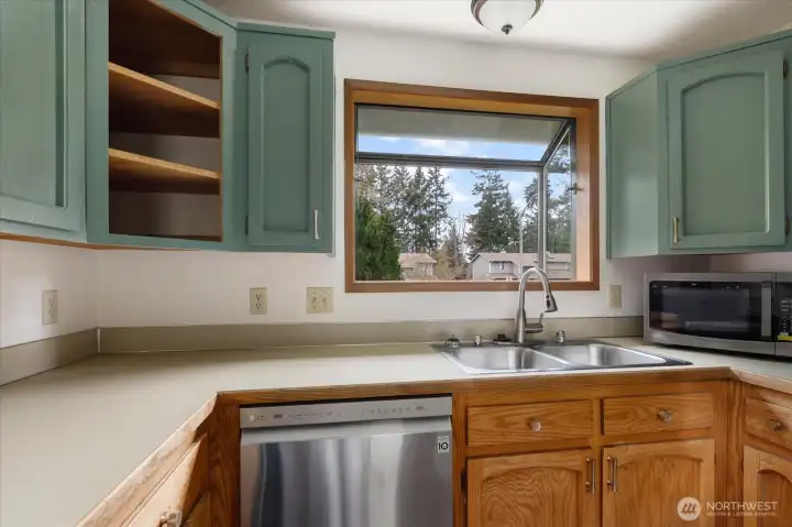Greenhouse window above kitchen sink for plants who need a little extra sun.