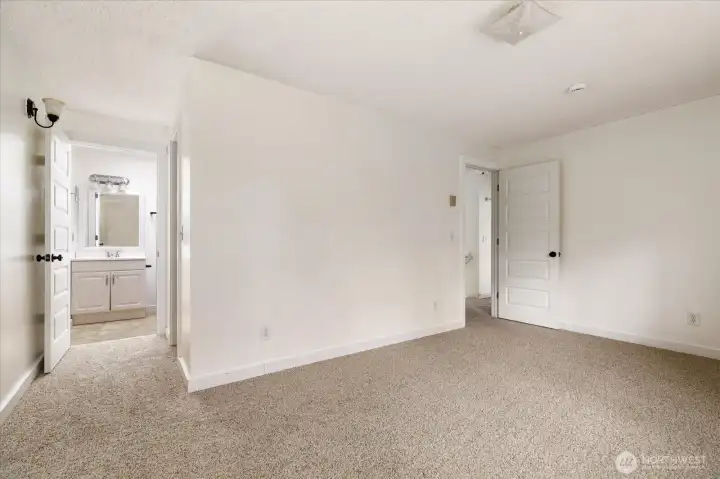 Primary bedroom with en suite bathroom and spacious walk-in closet.
