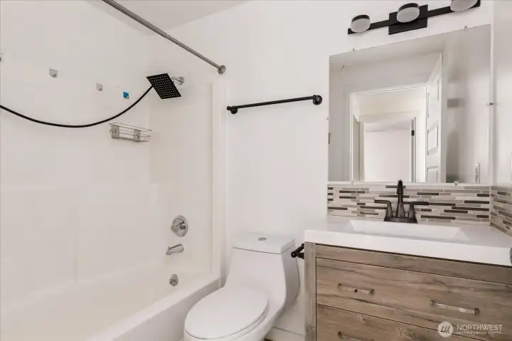 2nd full bathroom features dual shower head.