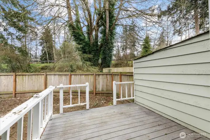 Back deck with privacy wall, adding privacy to an already secluded backyard.