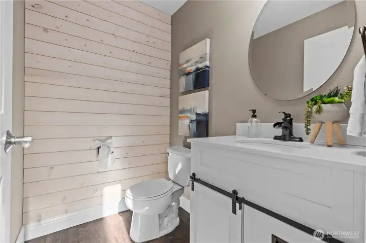 Updated powder room with wood accent wall.