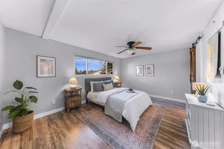 The inviting and spacious primary bedroom with plenty of room for all of your bedroom furniture