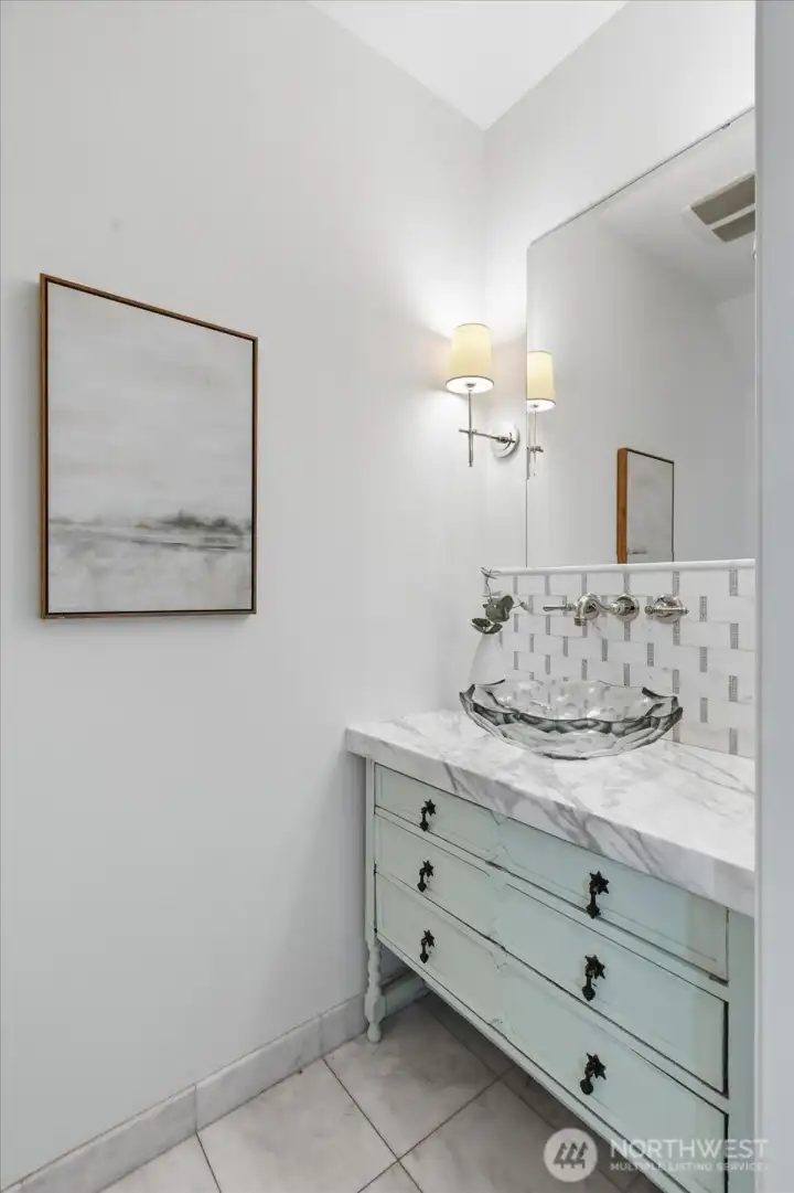 Stylish main floor powder room with designer sink/faucet and lighting, and antique style vanity