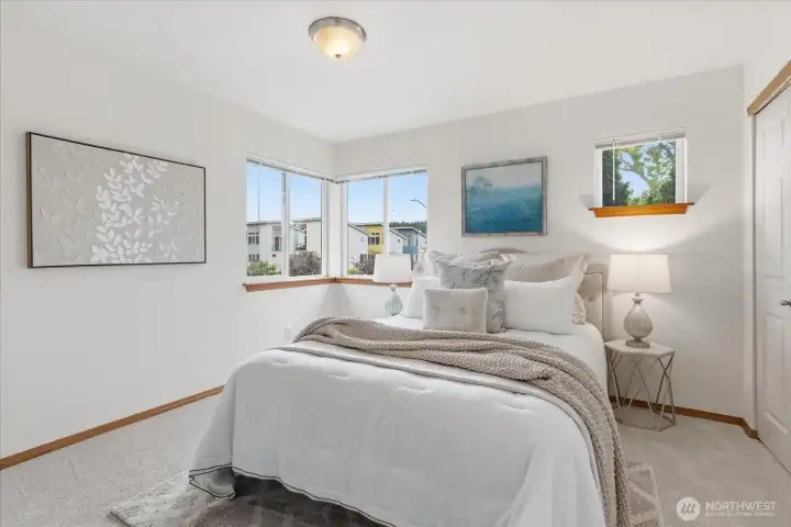 Spacious primary bedroom with great natural light and plenty of closet space