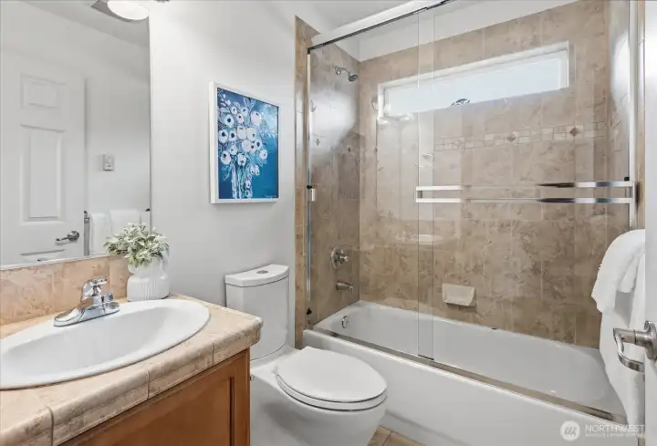 Full bath upstairs with full height tile tub surround