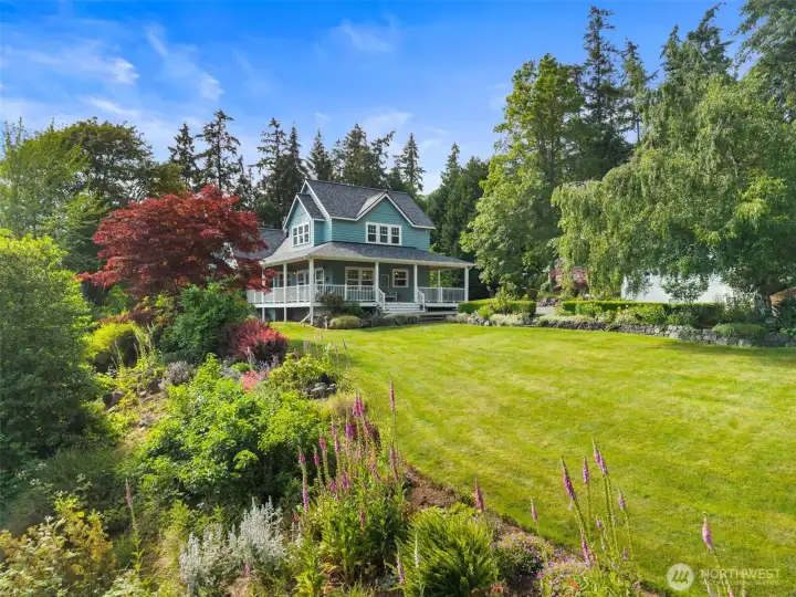 Set in the middle of an acre and a half, this lovely farmhouse is surrounded by flowers and fruit trees.