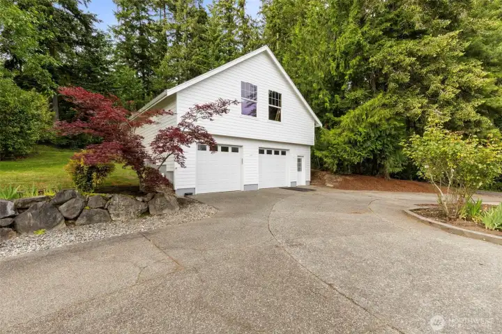 The ample garage has room for a shop plus an unfinished, vaulted space above.