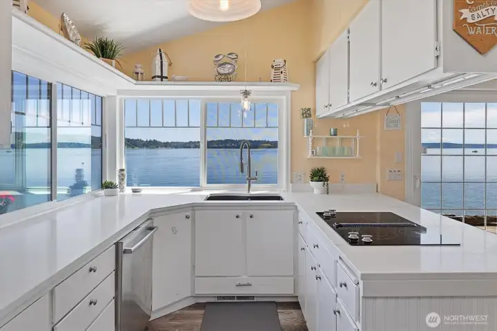 Updated countertops complement this bright kitchen with beautiful water views