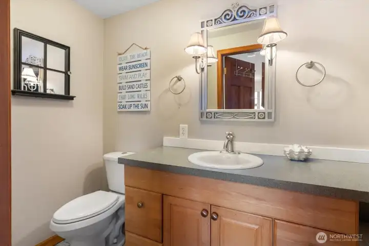 Downstairs bathroom with stackable Samsung washer dryer