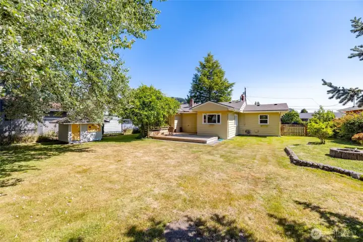 The backyard, viewed from the back of the property looking toward the home.