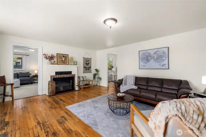 Original oak floors, a real wood-burning fireplace, and spacious living area enjoy lots of natural light from the south-facing front windows.