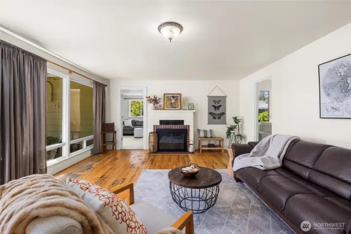The living room, looking toward the second living area through door at back left, and kitchen through door on right.