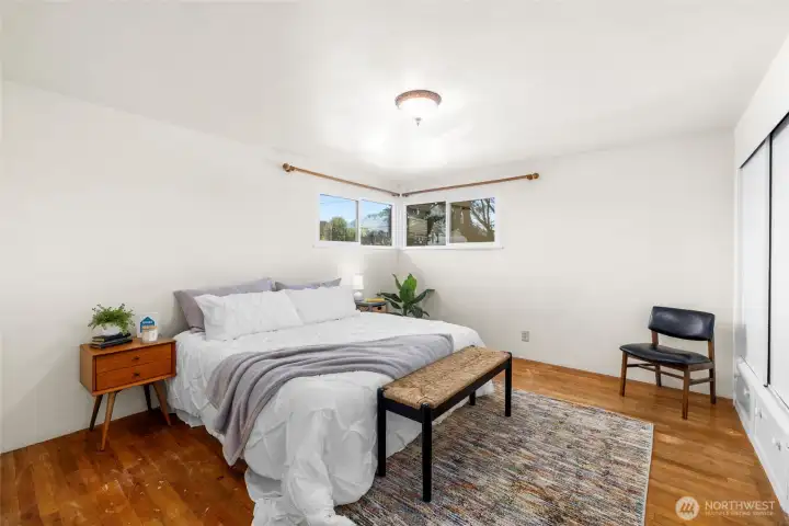 One of two extra large bedrooms.  Built-in drawers and closet. Oak floors.  Windows on two walls.