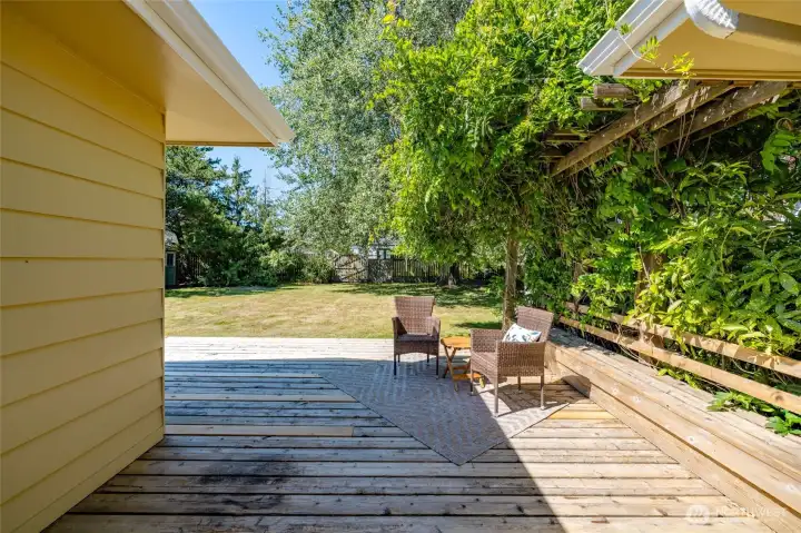 368/sf deck offers sunny spots and shady spots all day.  The wisteria trellis and built-in bench add charm and character.