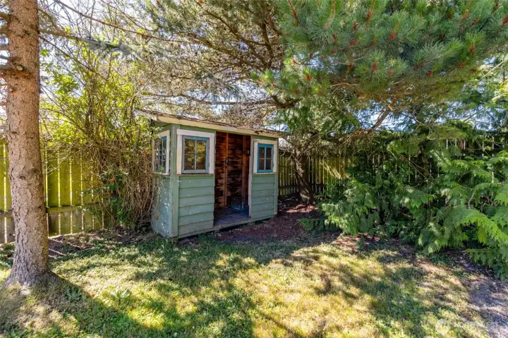 Open garden shed made with reclaimed materials.