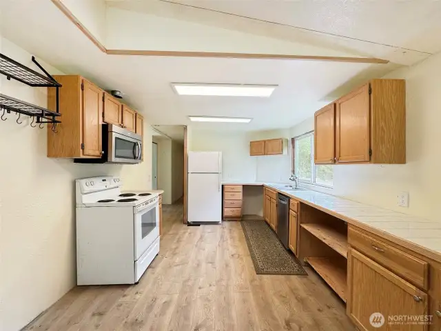 Closer view of the stove area in the kitchen. Notice the pot hanger to the left.